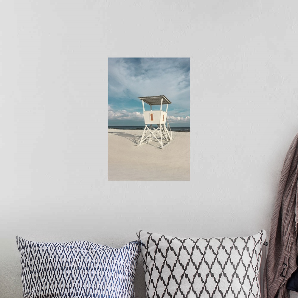 A bohemian room featuring A photo of a lifeguard tower on a cloudy day with an unoccupied beach in the background.