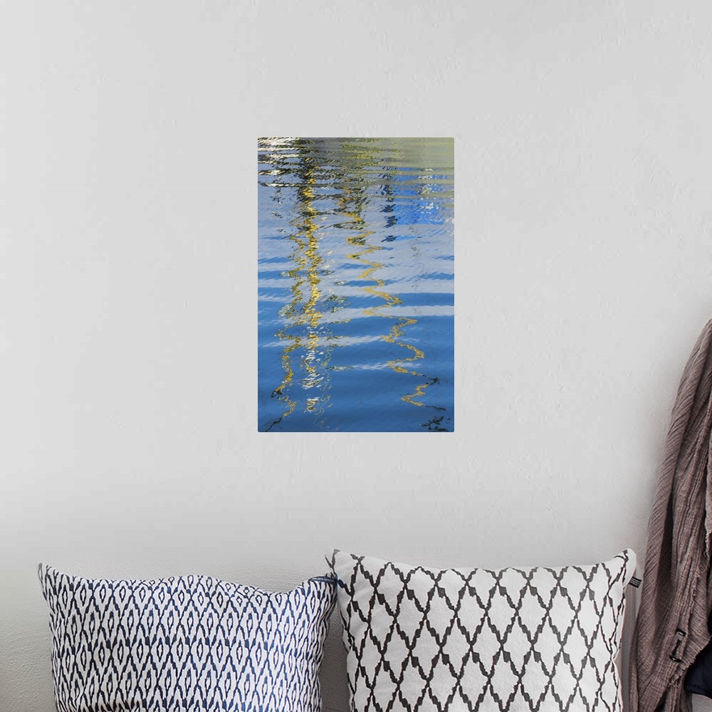 A bohemian room featuring Reflection of a boat on rippling water, creating an abstract image.