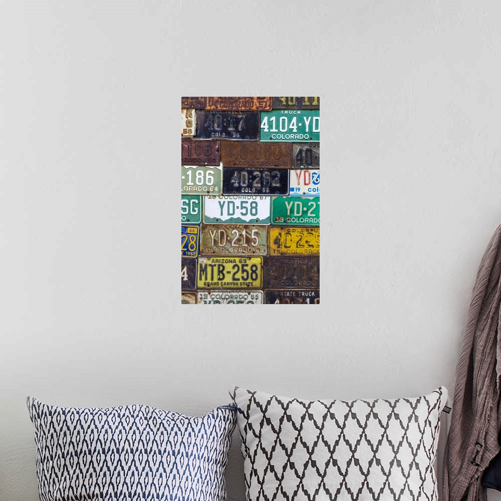 A bohemian room featuring A collection of vintage license plates.
