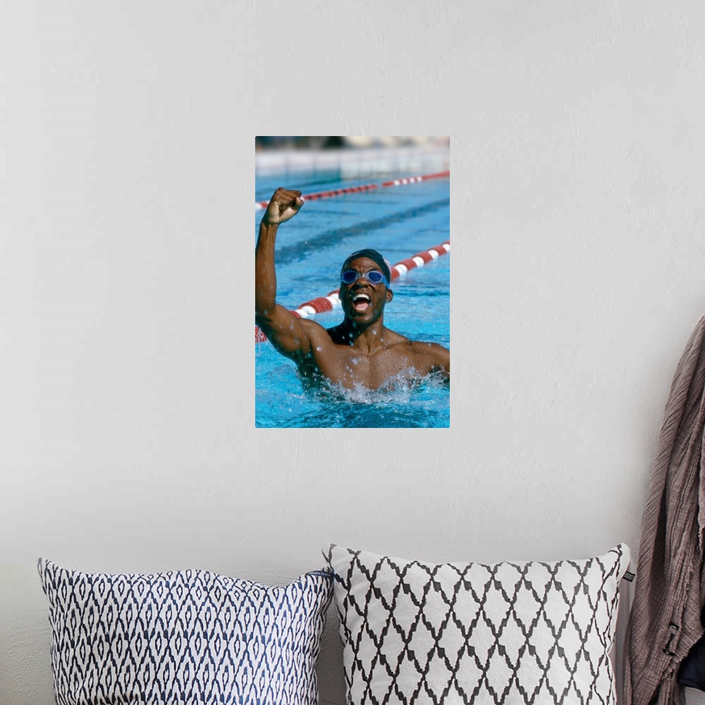 A bohemian room featuring portrait of a young male swimmer raising his hands in victory