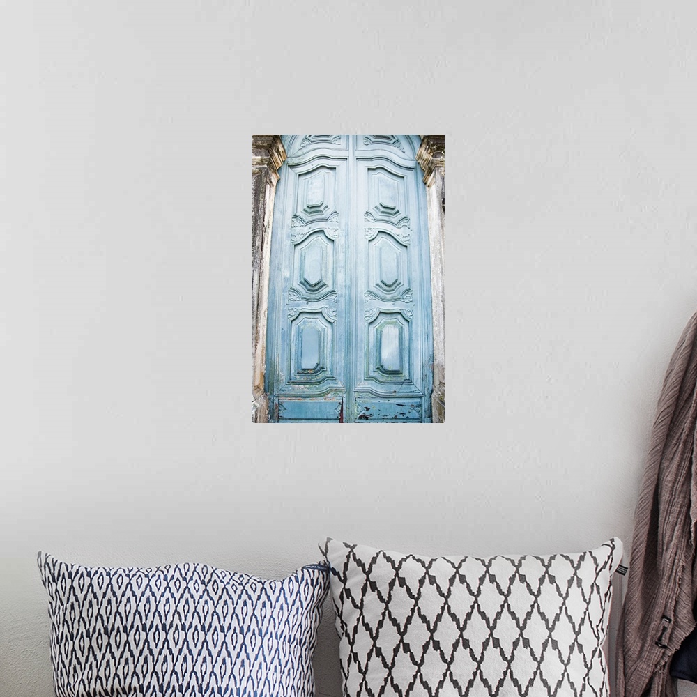A bohemian room featuring Vertical photo print of a tall antique door.