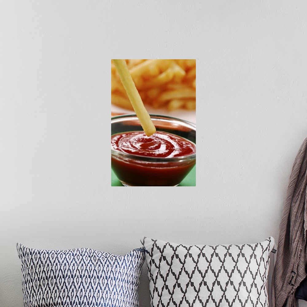 A bohemian room featuring Dipping French fries in ketchup, close up
