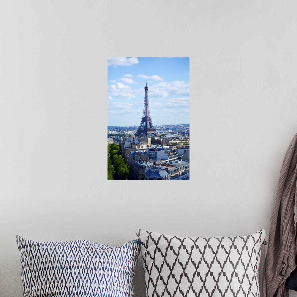 A bohemian room featuring Eiffel Tour against clouds in sky.