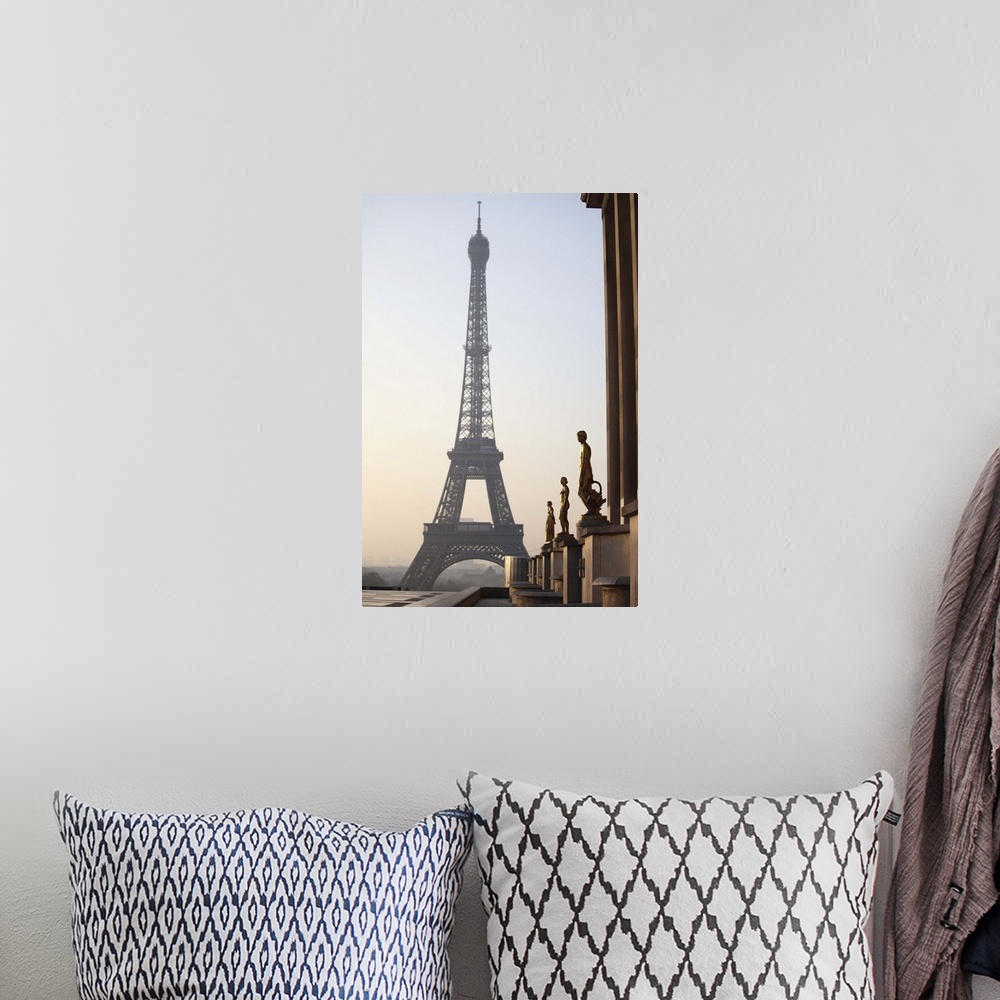 A bohemian room featuring Eiffel tower with statues in the foreground
