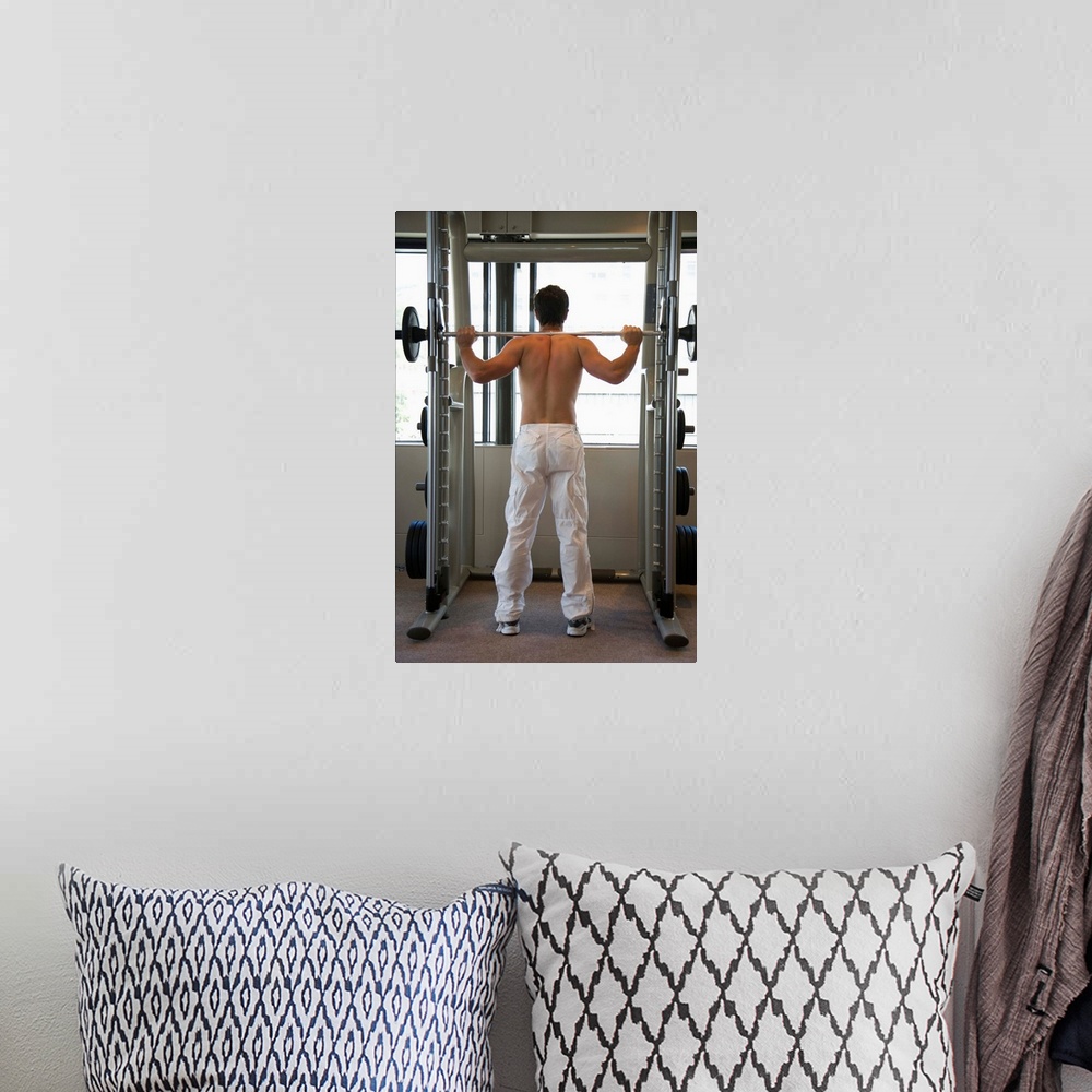 A bohemian room featuring Man lifting barbell