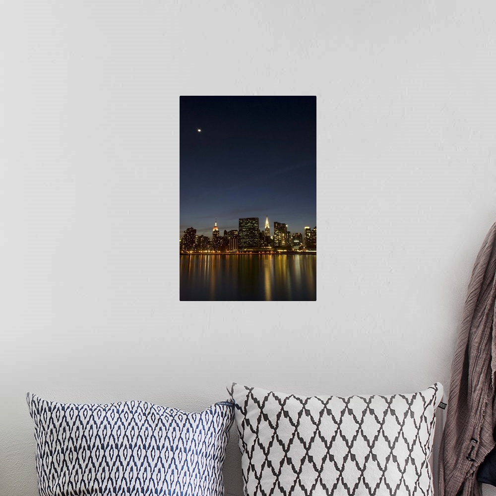 A bohemian room featuring Midtown Manhattan at dusk with the moon above and reflection of the building lights in the East R...