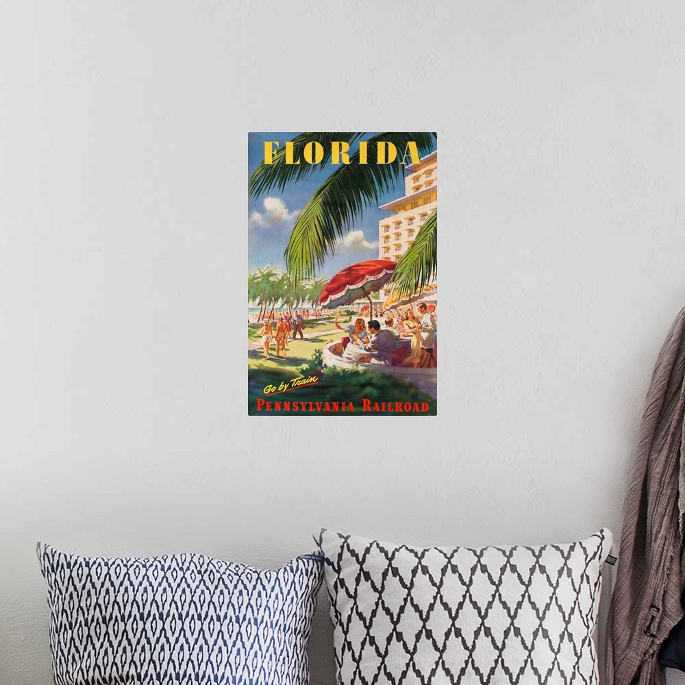 A bohemian room featuring ca 1950's travel poster. Happy couples dine and relax ocean side, next to stylish hotel