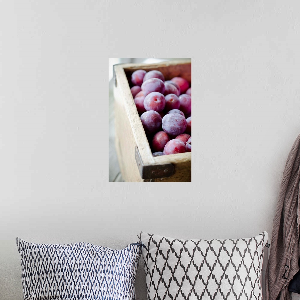 A bohemian room featuring Plums in wooden box.