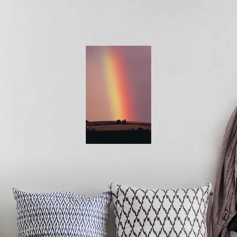 A bohemian room featuring Rainbow in a sunset sky