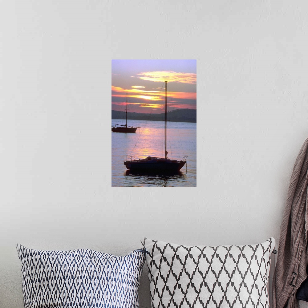 A bohemian room featuring Sailboats in water at sunrise