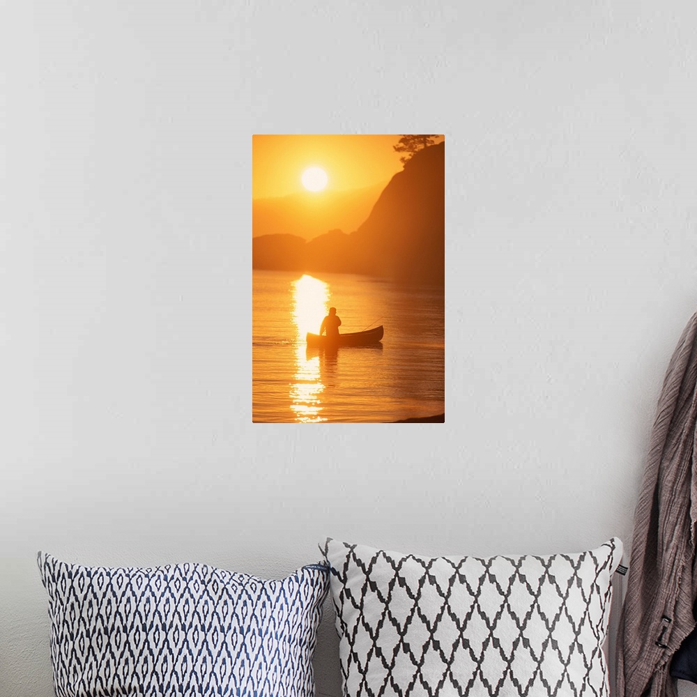 A bohemian room featuring Silhouette of person canoeing at sunset