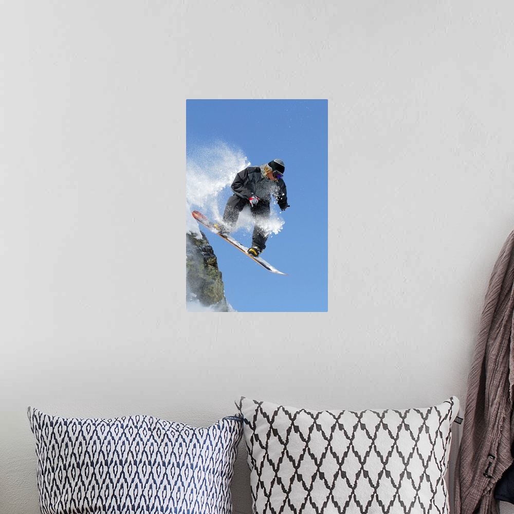 A bohemian room featuring Snowboarder jumping off ledge