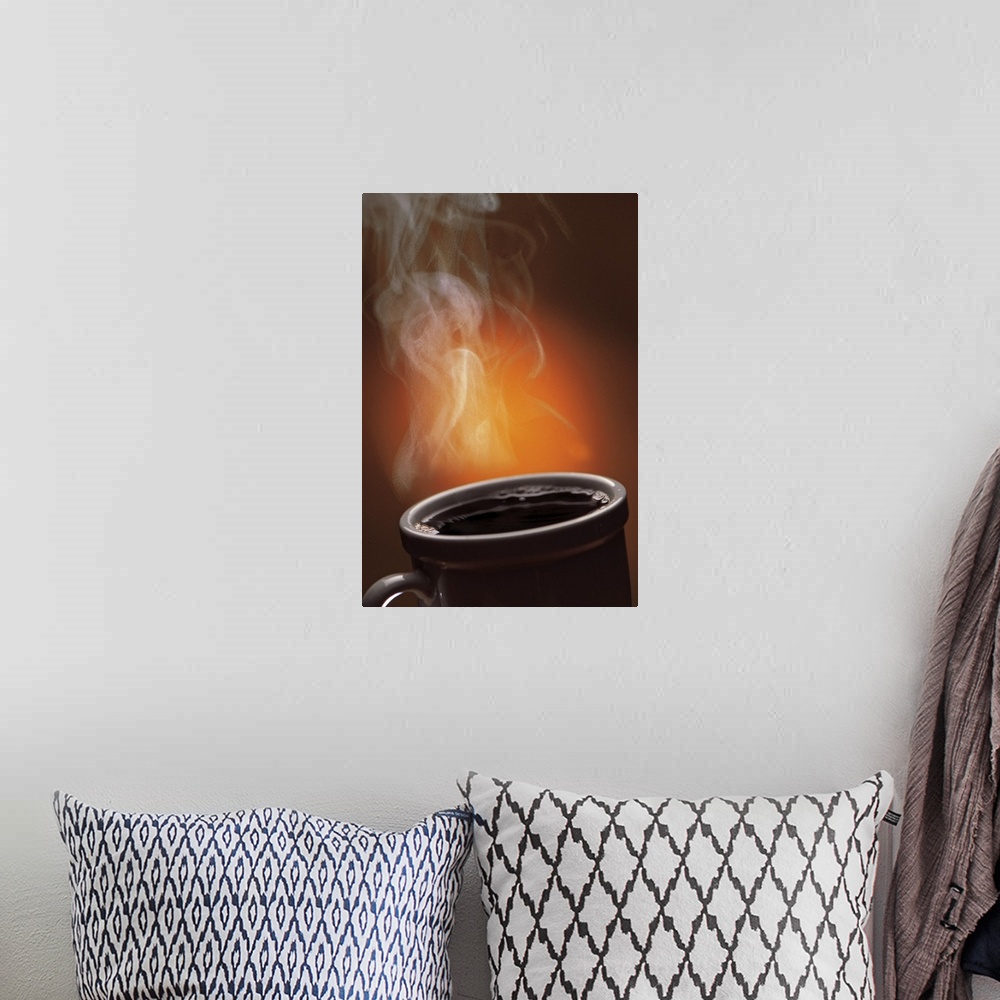 A bohemian room featuring This large vertical piece is a picture taken of a cup of black coffee with steam coming off of it.