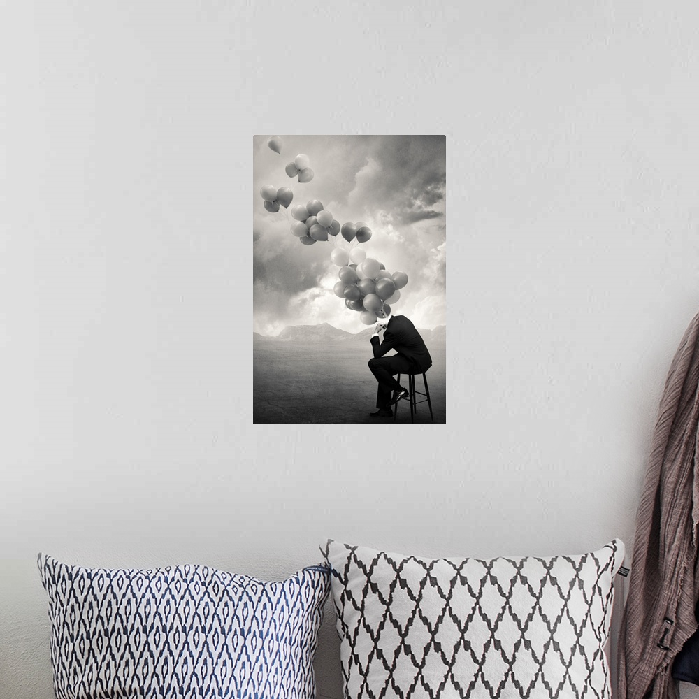 A bohemian room featuring An abstract art photograph of a hollow business suit seated on a stool, with balloons hovering ou...