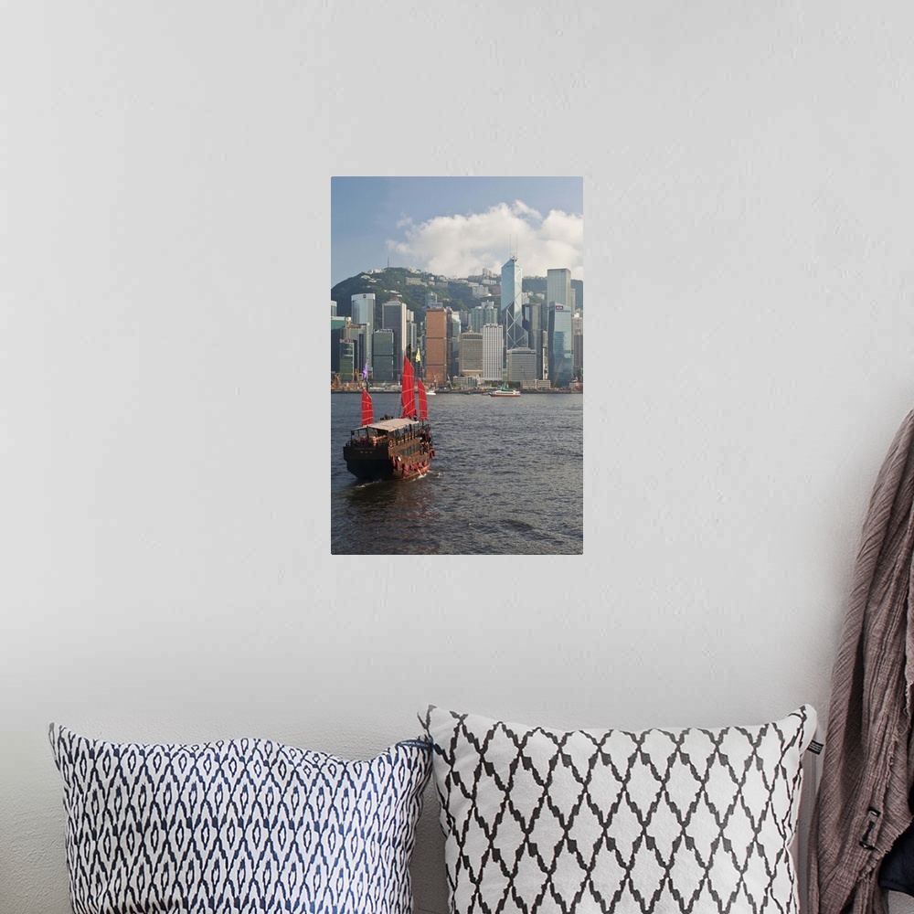 A bohemian room featuring One of the last remaining Chinese sailing junks on Victoria Harbour, Hong Kong, China, Asia, view...