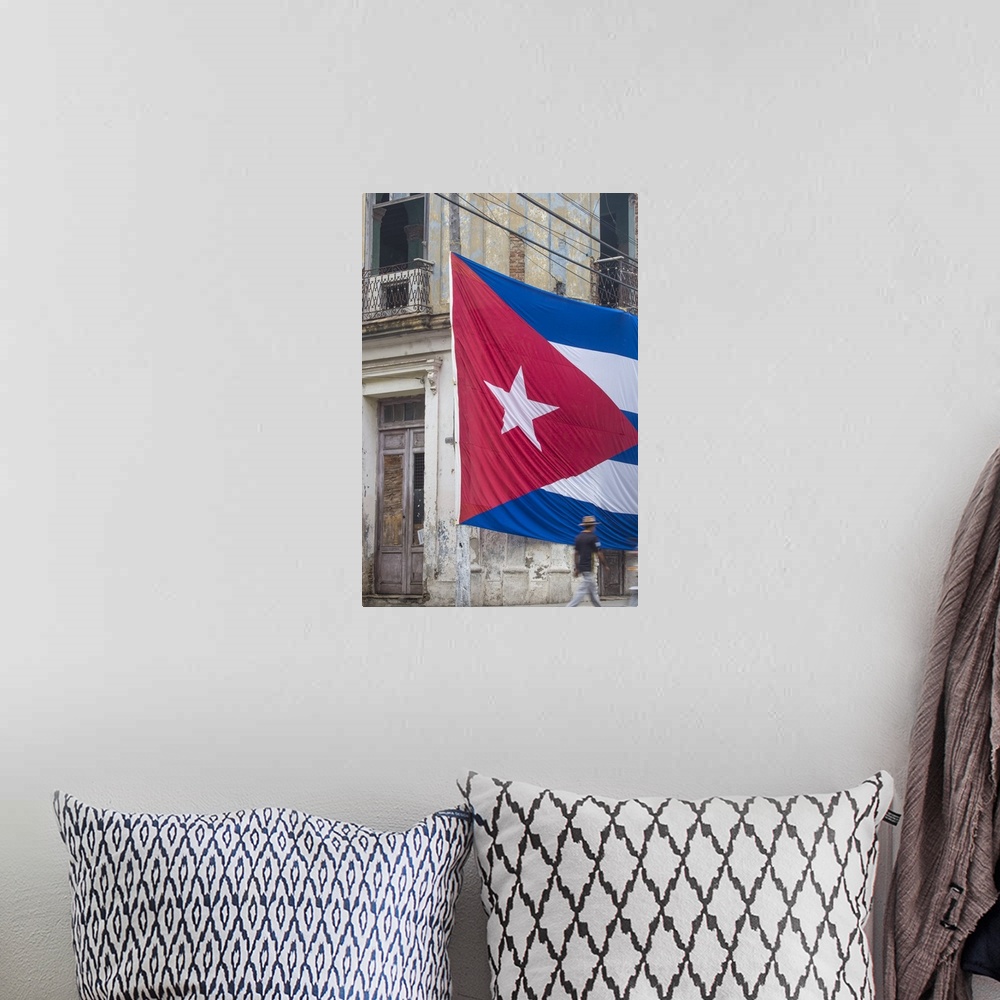 A bohemian room featuring Cuba, Huge Cuban flag hanging across buildings in a street in  Santa Clara, after the death of Fi...