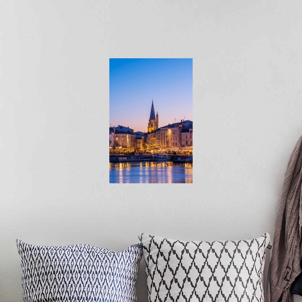 A bohemian room featuring France, Poitou Charentes, La Rochelle, Old Harbour and lantern tower at dusk.