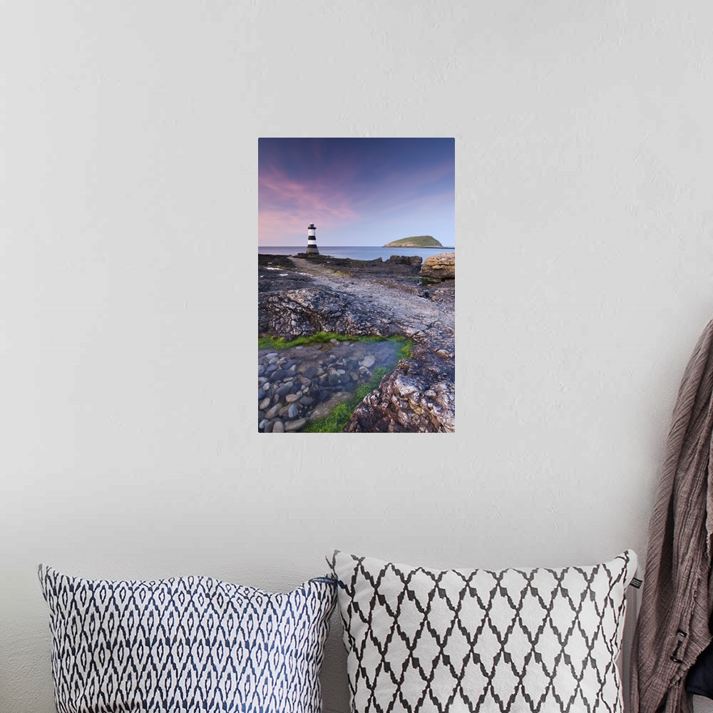 A bohemian room featuring Twilight on the rocky Anglesey coast looking towards Penmon Point Lighthouse and Puffin Island, A...