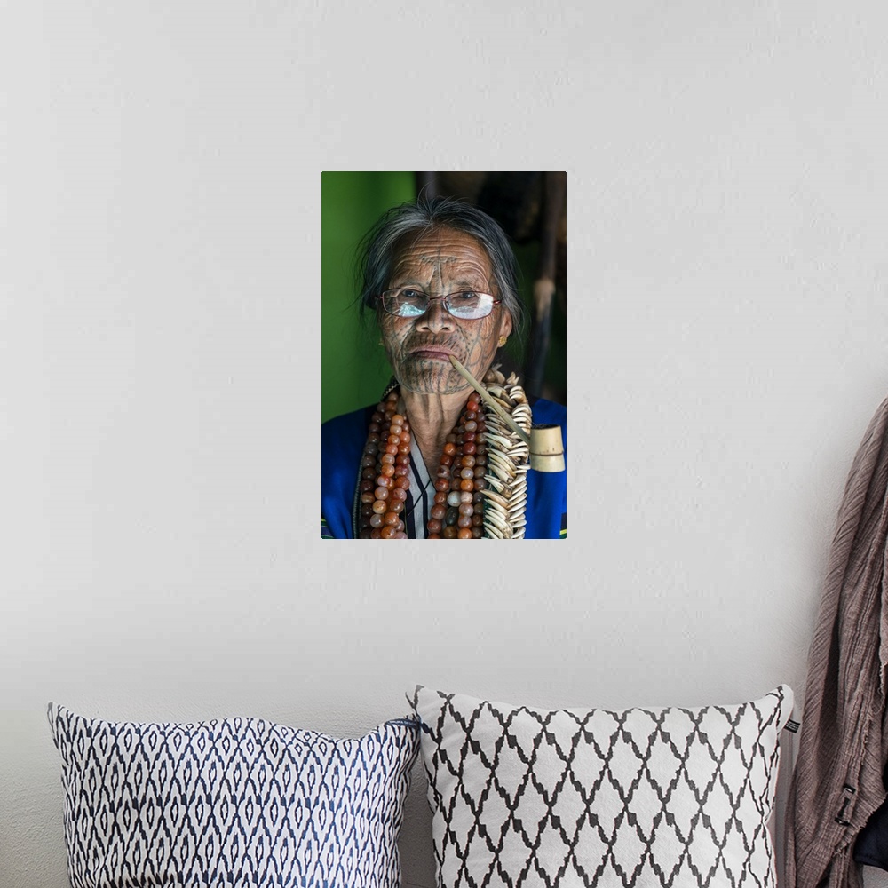 A bohemian room featuring Close-up portrait of old lady with glasses and traditional facial tattoo smoking a pipe, Mindat, ...