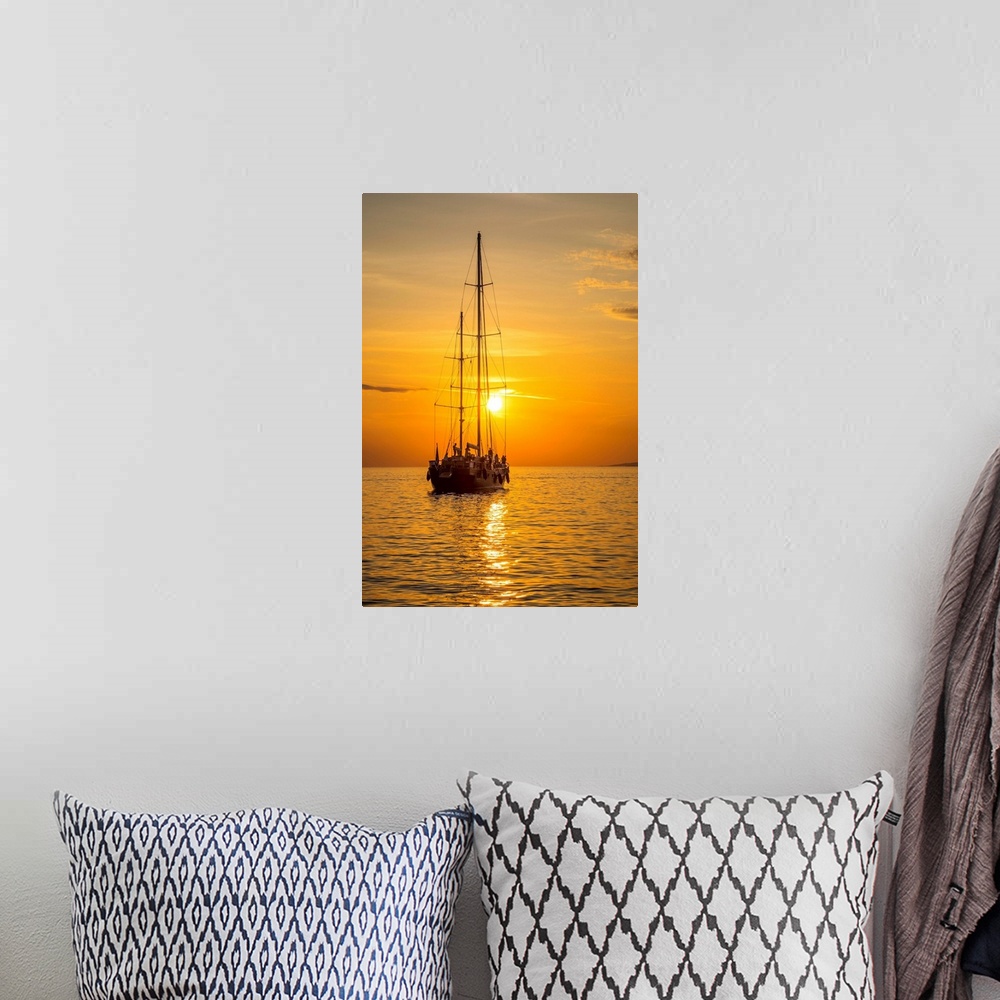 A bohemian room featuring Sailing boat at sunset, Mykonos Town, Mykonos, Cyclade Islands, Greece.