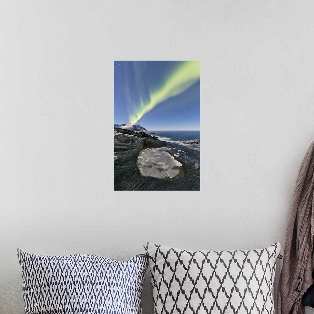A bohemian room featuring The Northern Lights illuminates the rocky peaks and icy sea in the polar night Tungeneset Senja T...
