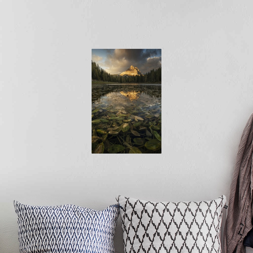 A bohemian room featuring The Tre Cime di Lavaredo reflecting in the Antorno lake during an early autumn sunset, with some ...