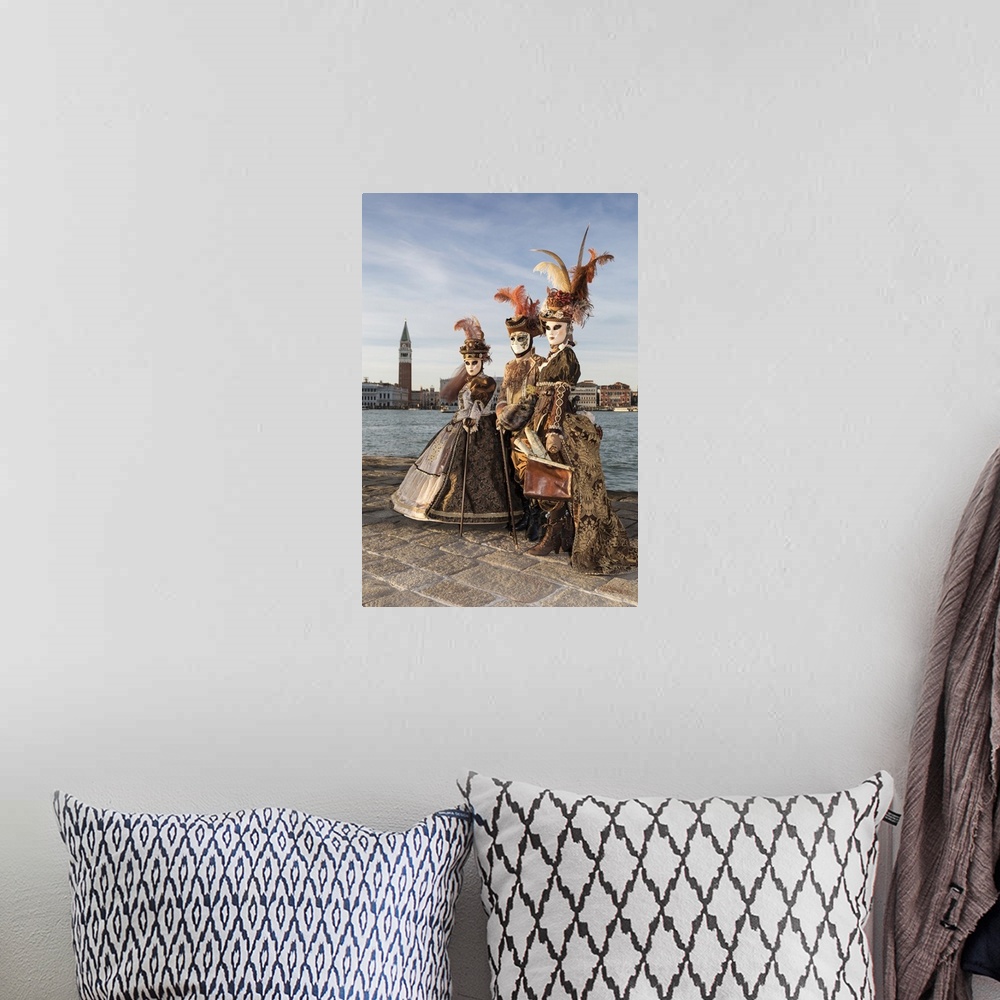 A bohemian room featuring Three people in costume at Carnival time, San Giorgio Maggiore, Venice, Veneto, Italy
