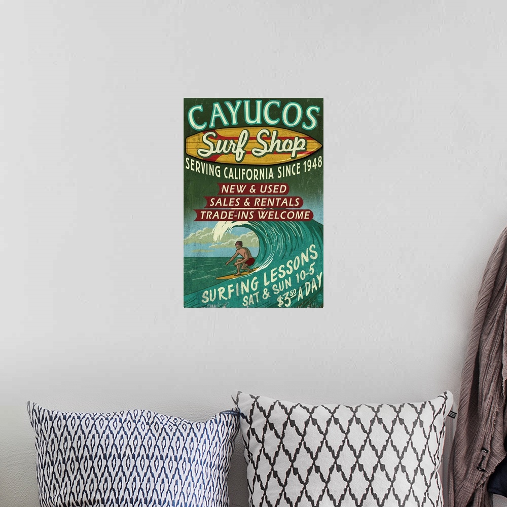 A bohemian room featuring Retro stylized art poster of vintage sign with a surfer in a curled wave on the ocean.