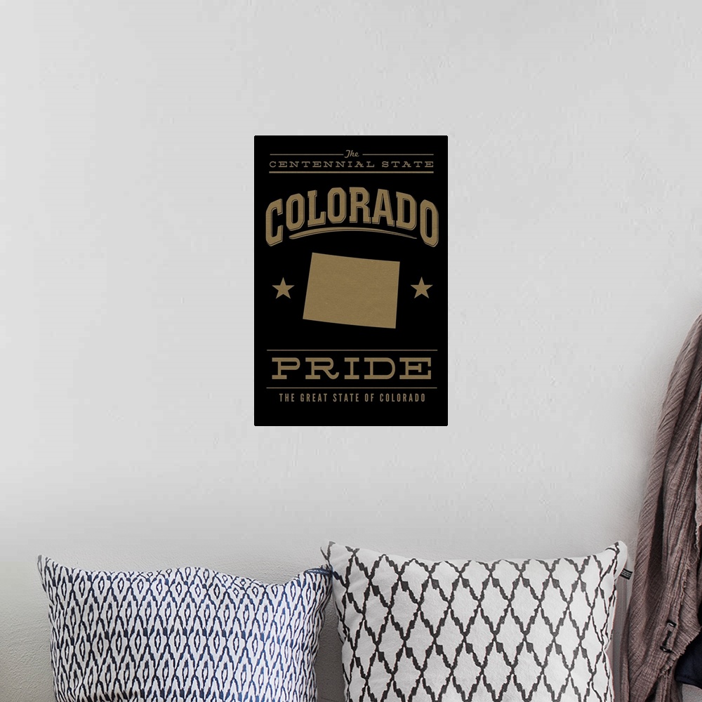 A bohemian room featuring The Colorado state outline on black with gold text.