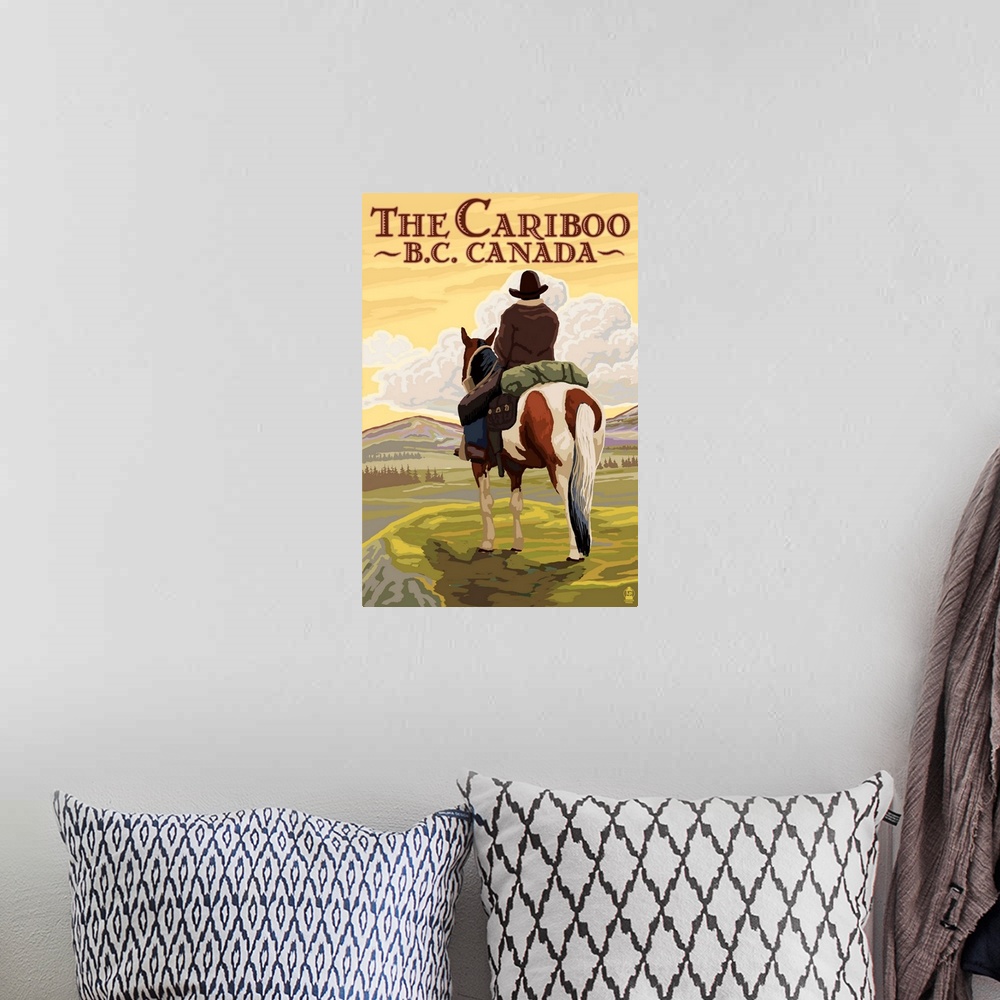 A bohemian room featuring Retro stylized art poster of a cowboy on horseback looking out over a rugged landscape.