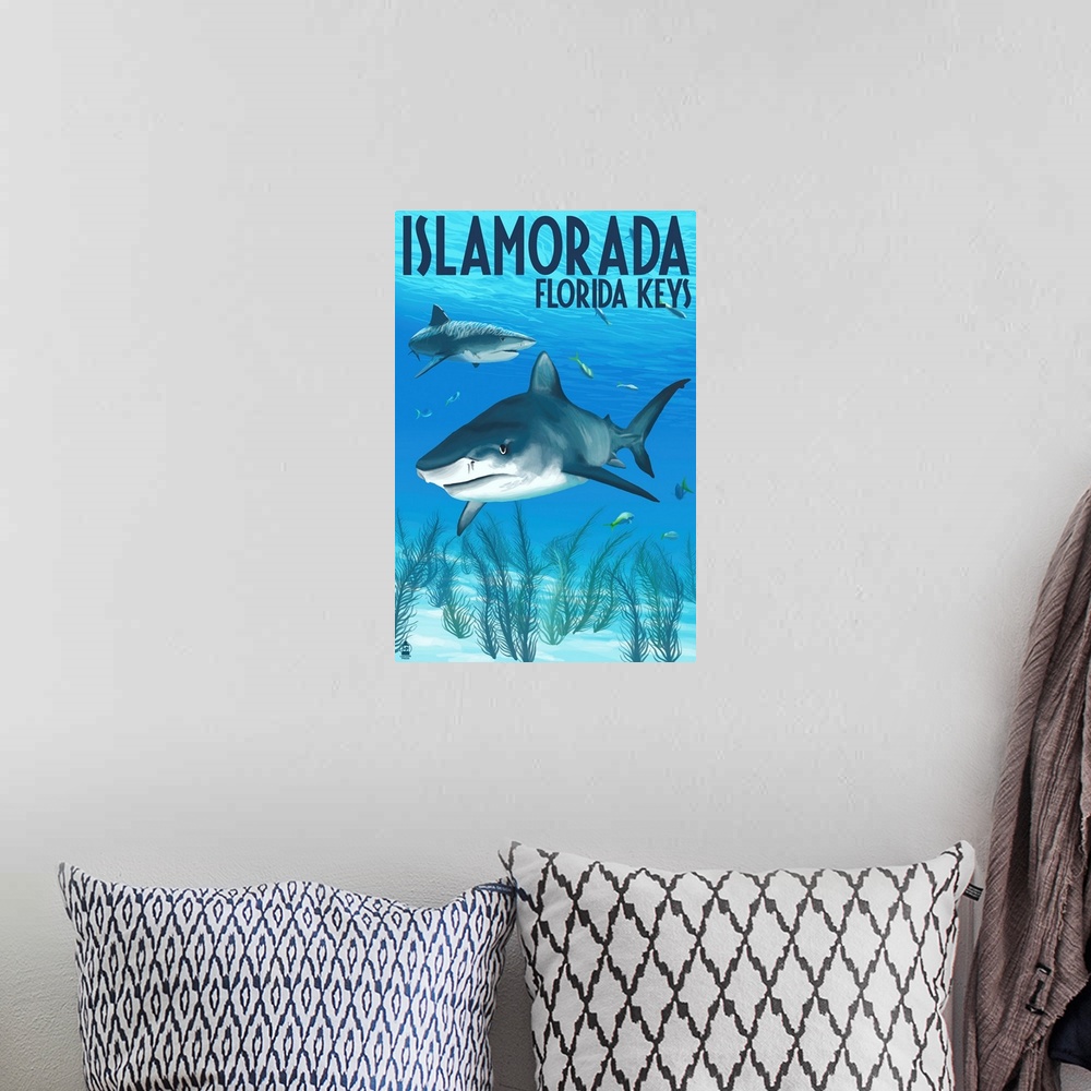 A bohemian room featuring A stylized art poster of sharks swimming near the shallow ocean floor off the coast.