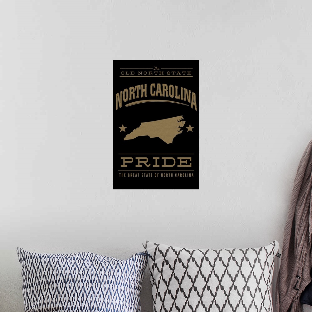 A bohemian room featuring The North Carolina state outline on black with gold text.