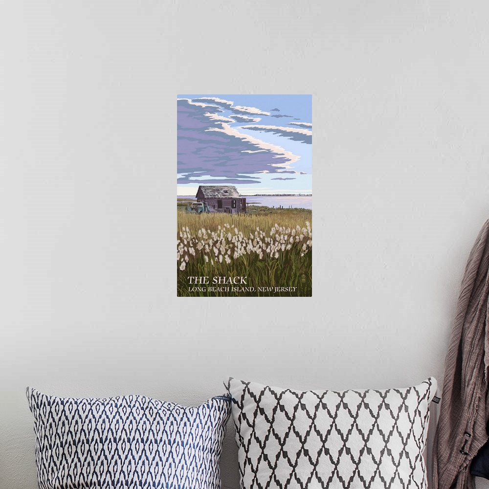 A bohemian room featuring Retro stylized art poster of a field of tall grass with an old shack, under a cloudy sky.