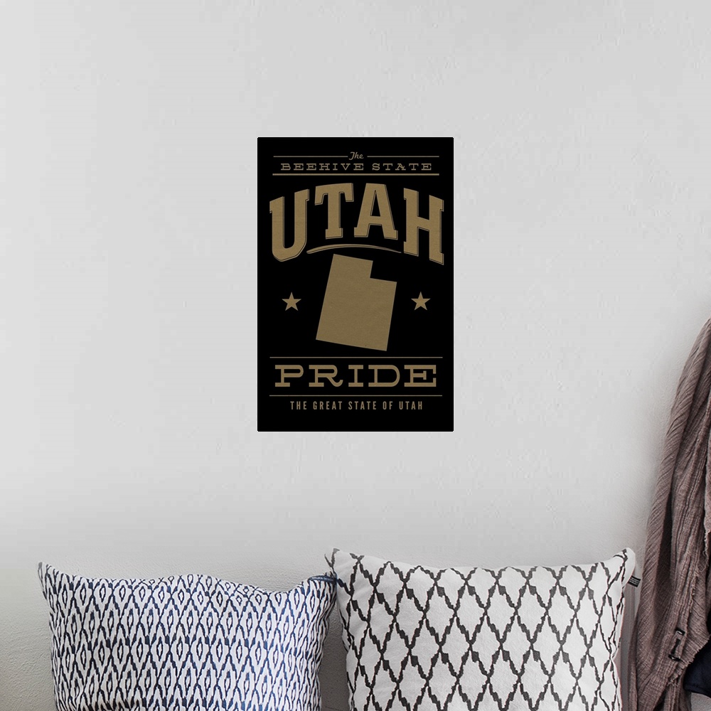 A bohemian room featuring The Utah state outline on black with gold text.