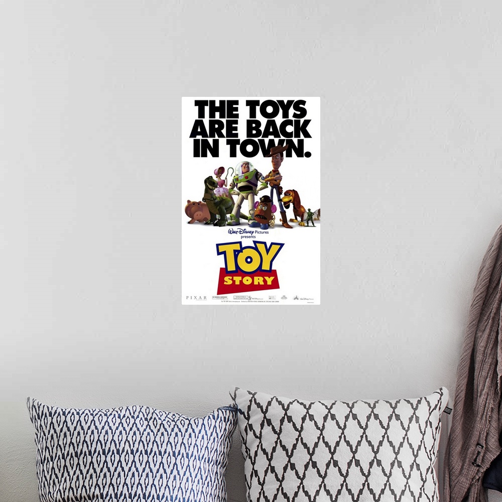 A bohemian room featuring Movie poster for Toy Story with all of the popular toys in the center of the poster and the text ...