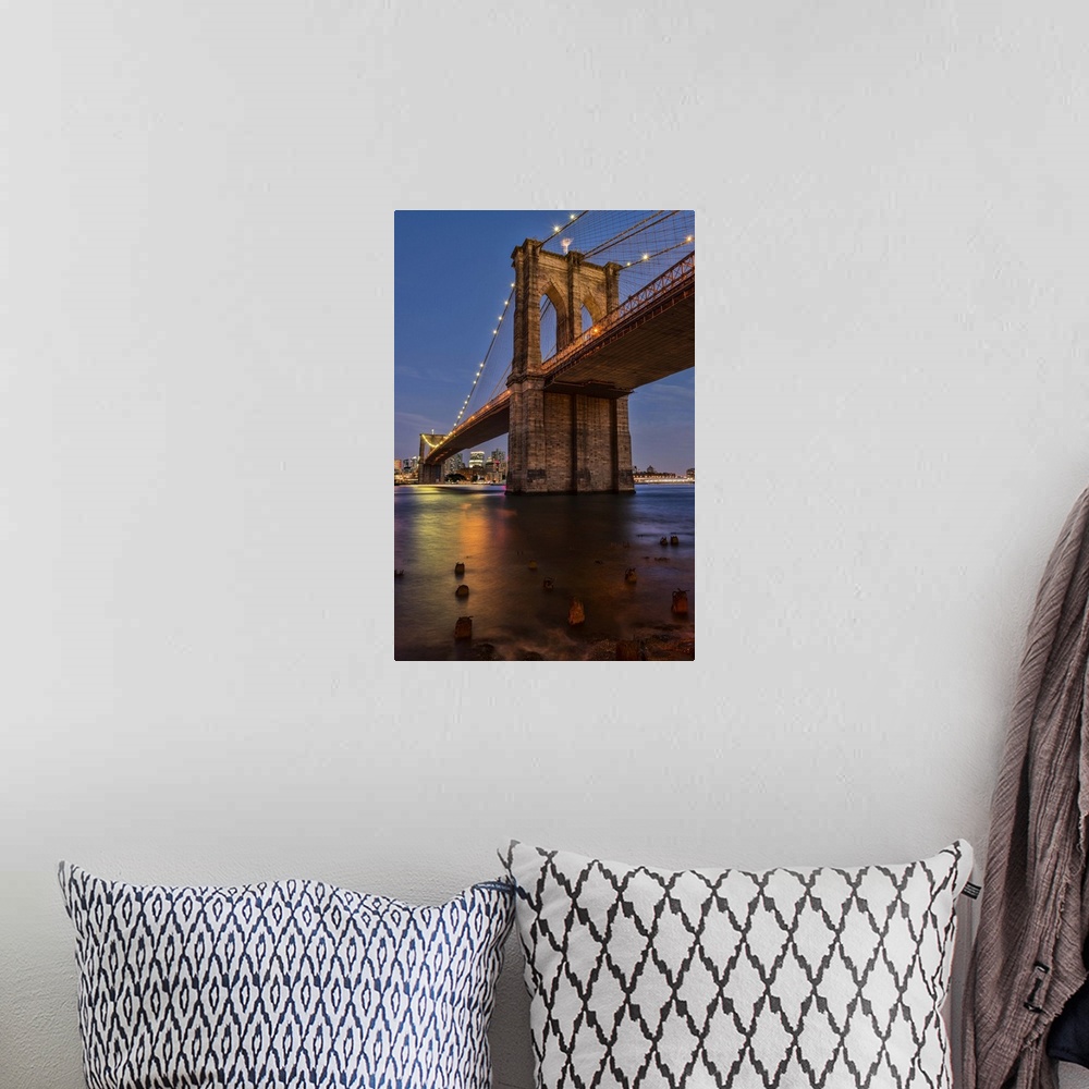 A bohemian room featuring A photograph of the Brooklyn bridge at twilight.