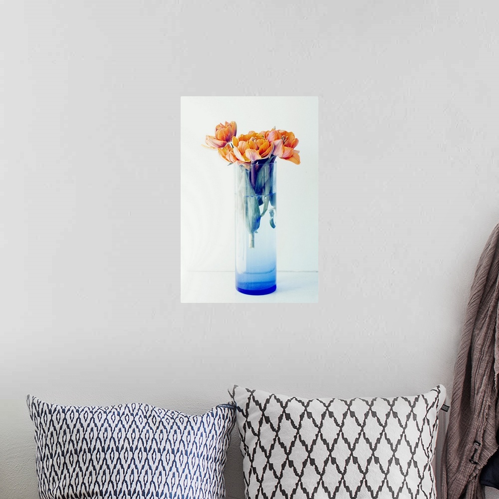 A bohemian room featuring Orange Tulips in a Blue Vase