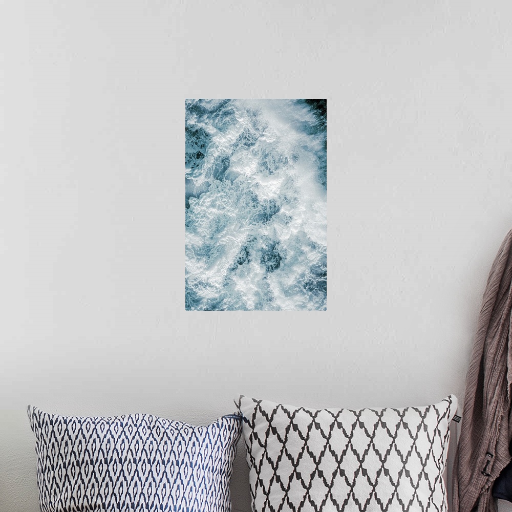 A bohemian room featuring Aerial photography picture of a huge wave from above showing droplets.