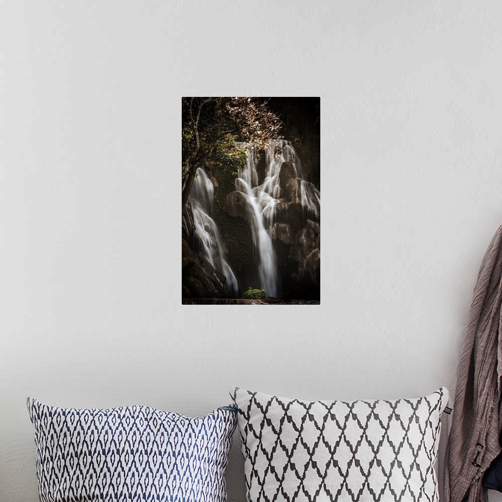 A bohemian room featuring Waterfall in a forest between shadows and light