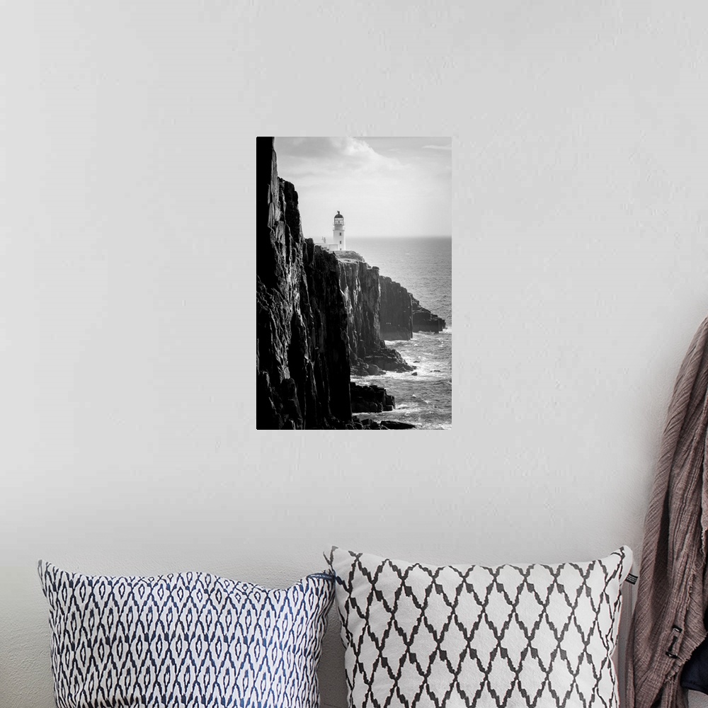 A bohemian room featuring Fine art photo of a lighthouse at the edge of a cliff by the ocean in black and white.