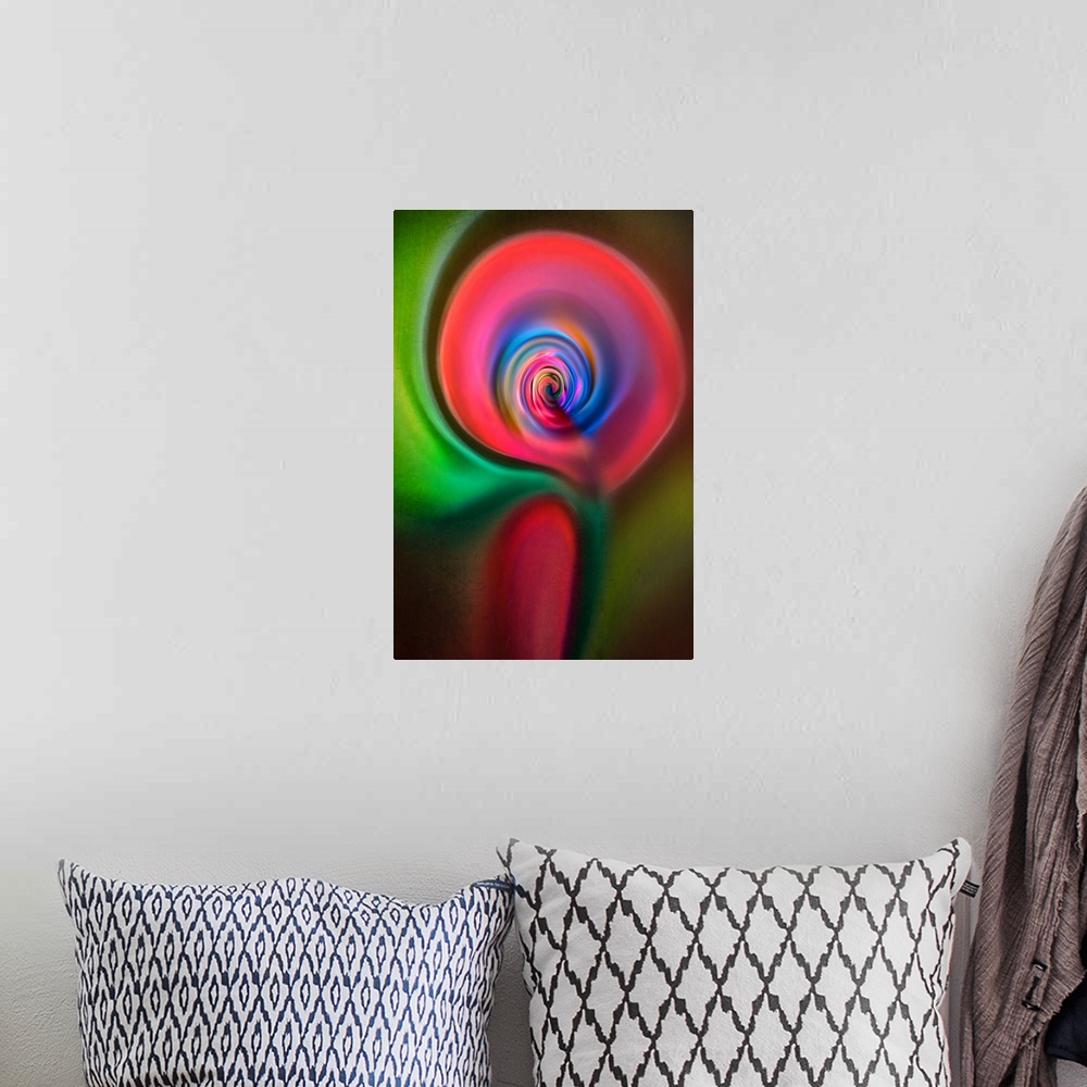 A bohemian room featuring Abstract photograph in green and red swirling shapes, resembling a candle.