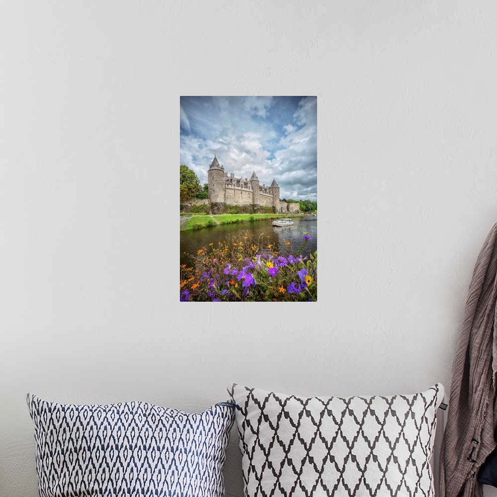 A bohemian room featuring View of a medieval castle from across the river with flowers.