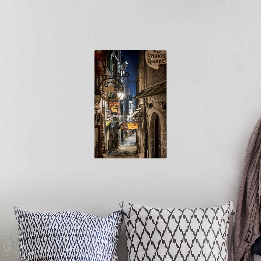 A bohemian room featuring A photograph of a road in a French village.