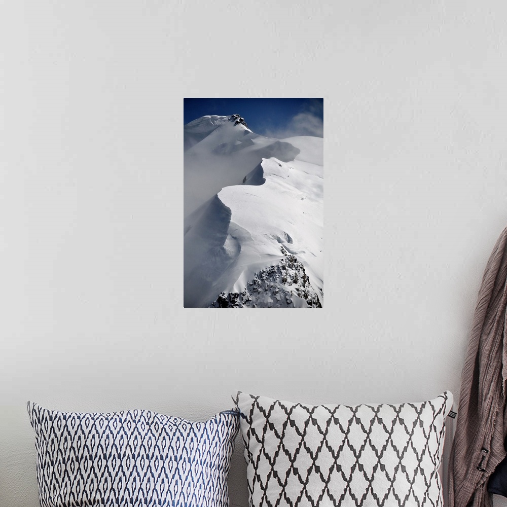 A bohemian room featuring Mont Blanc du Tacul mountain of the French Alps in France with snow, sun and wind, vertical view.