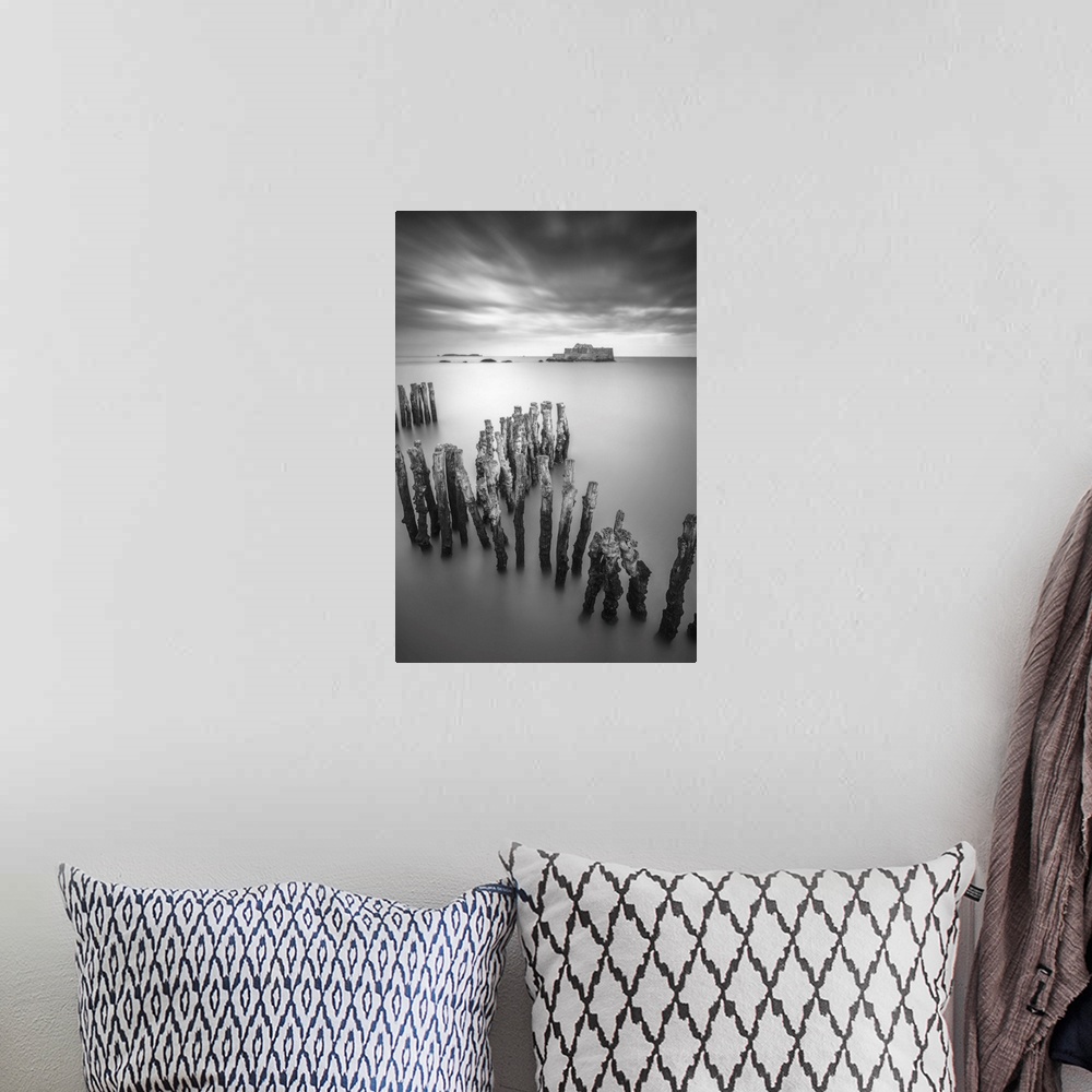 A bohemian room featuring Black and white vertical long time exposure view of the shorecoast of Saint Malo in Brittany, a v...