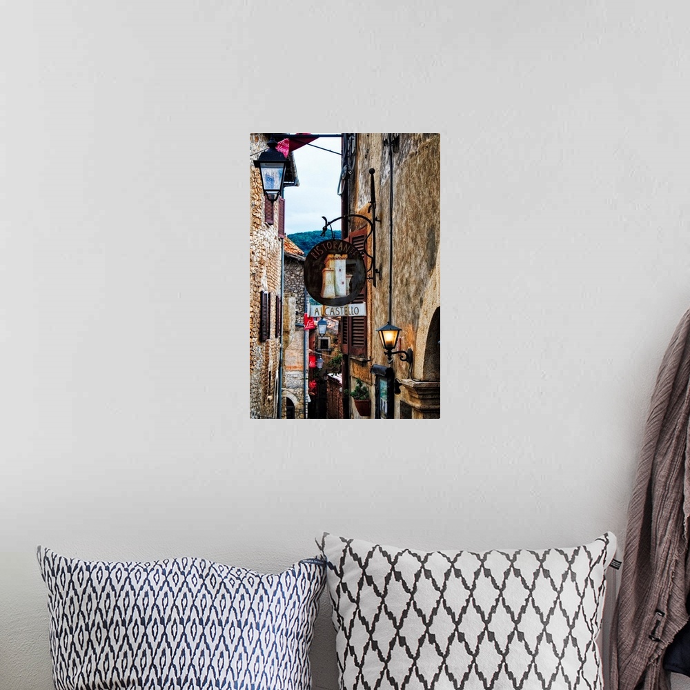 A bohemian room featuring Narrow Medieval street with signs and lamps, Sermoneta,Latina,  Italy.
