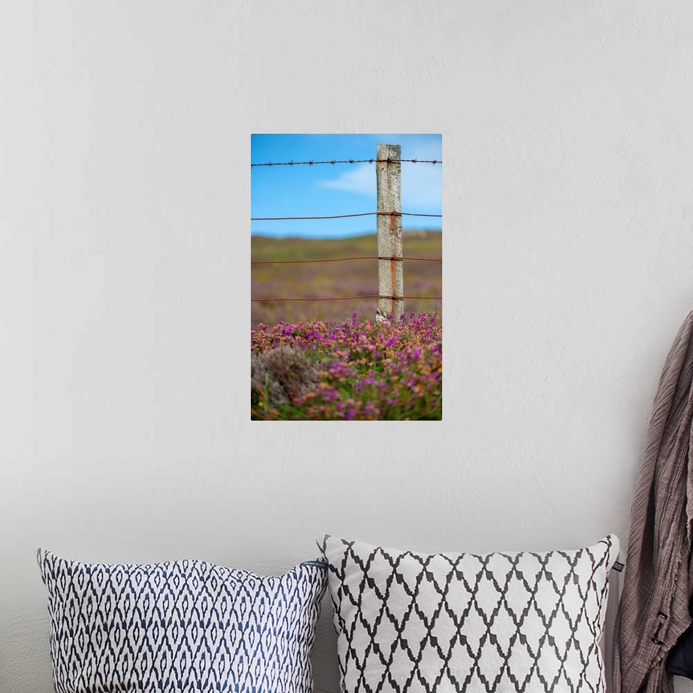 A bohemian room featuring Fine art photo of a wooden post with wire in a field of purple flowers.