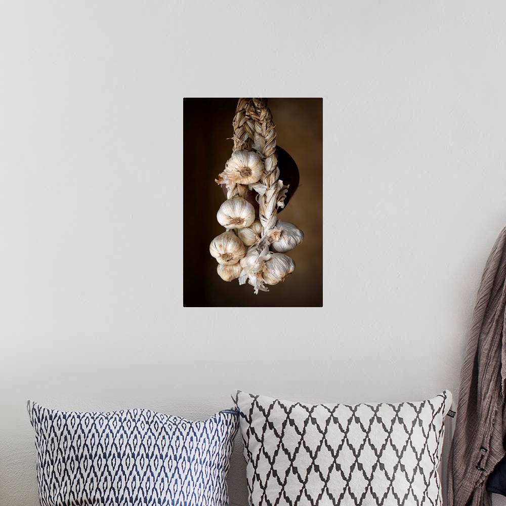 A bohemian room featuring A photograph of hanging garlic cloves.