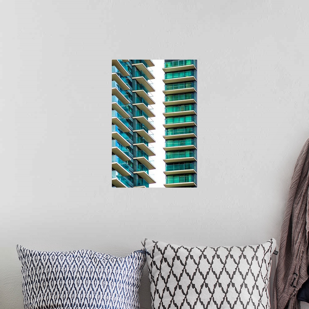 A bohemian room featuring A photograph of blue and green glass buildings.