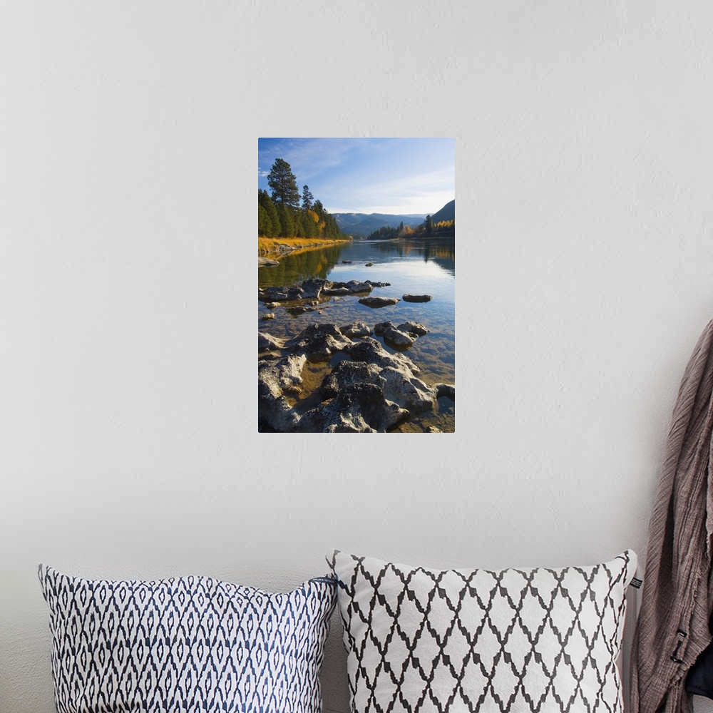 A bohemian room featuring Clouds and distant mountains reflected in rocky Kootenai River, Montana